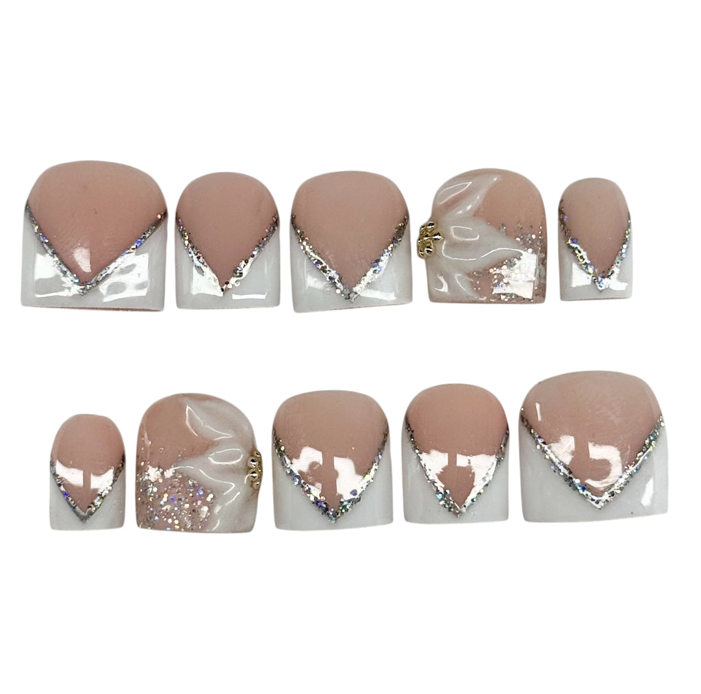 Set of beige and white nail art designs with decorative elements on a white background