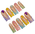 Set of pastel-colored nail art decorations on a white background