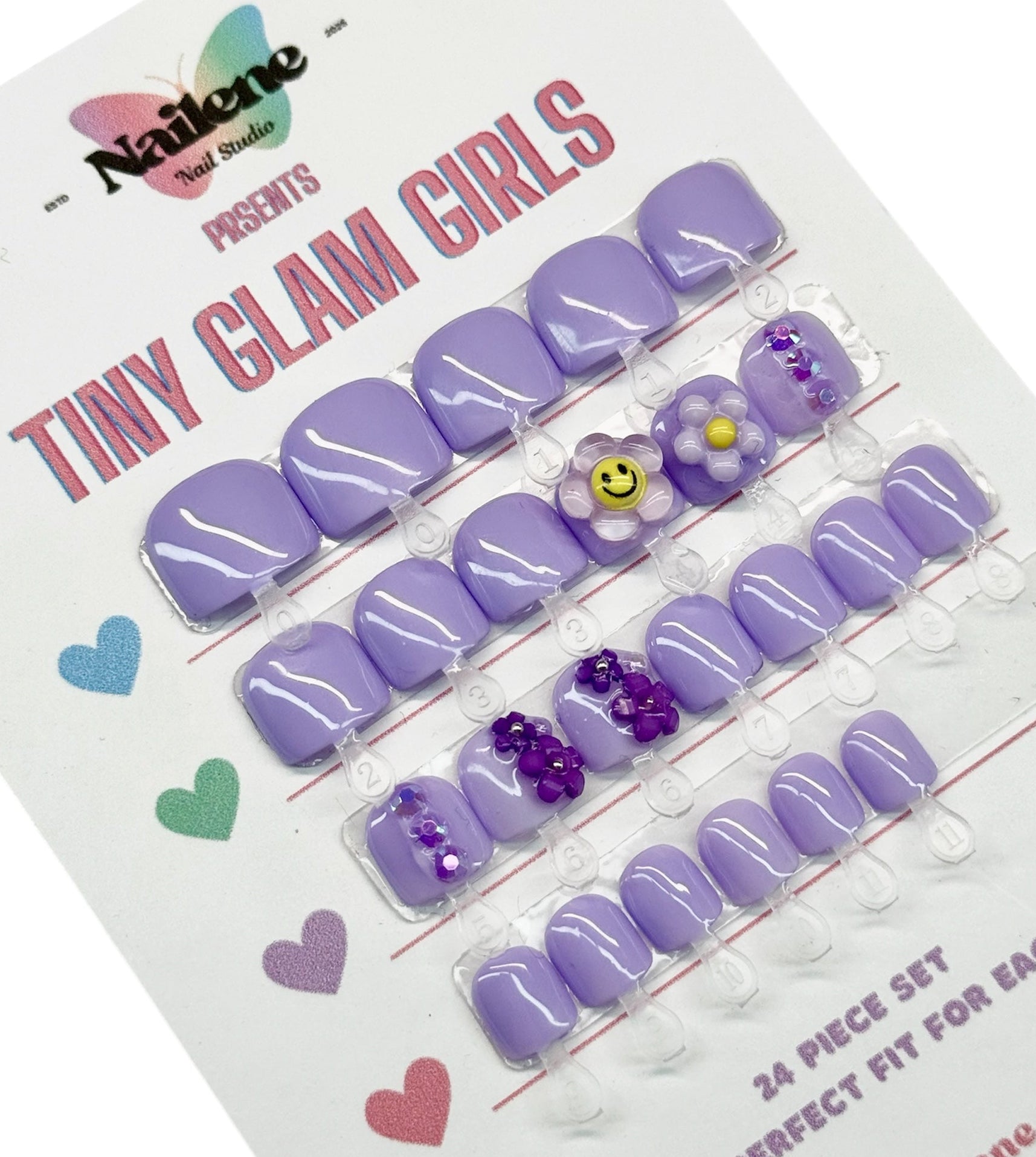 Packaged purple false nails with decorative elements on a white background