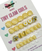 Packaged yellow nail art set with decorative elements on a white background