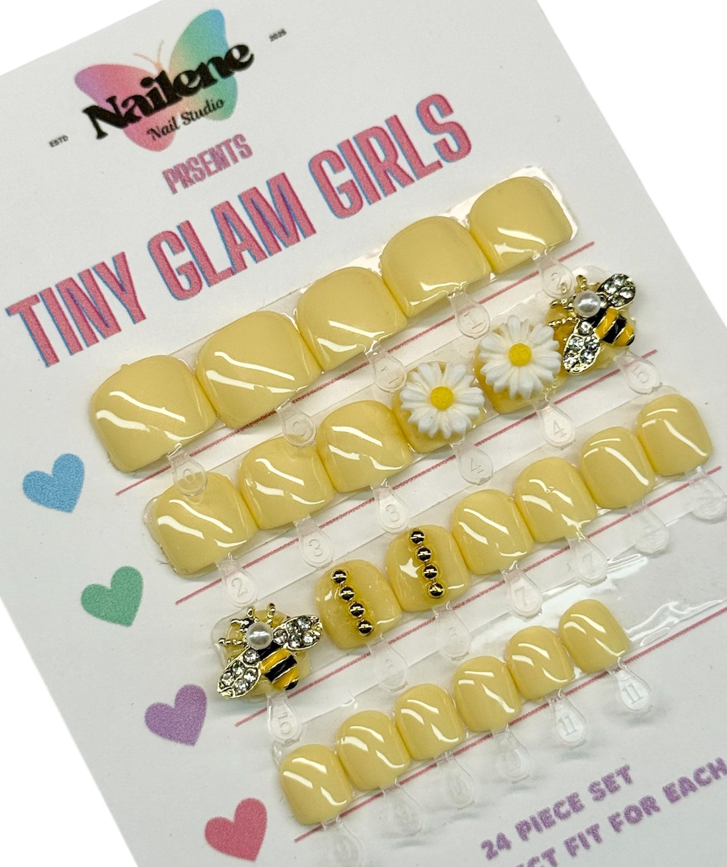 Packaged yellow nail art set with decorative elements on a white background