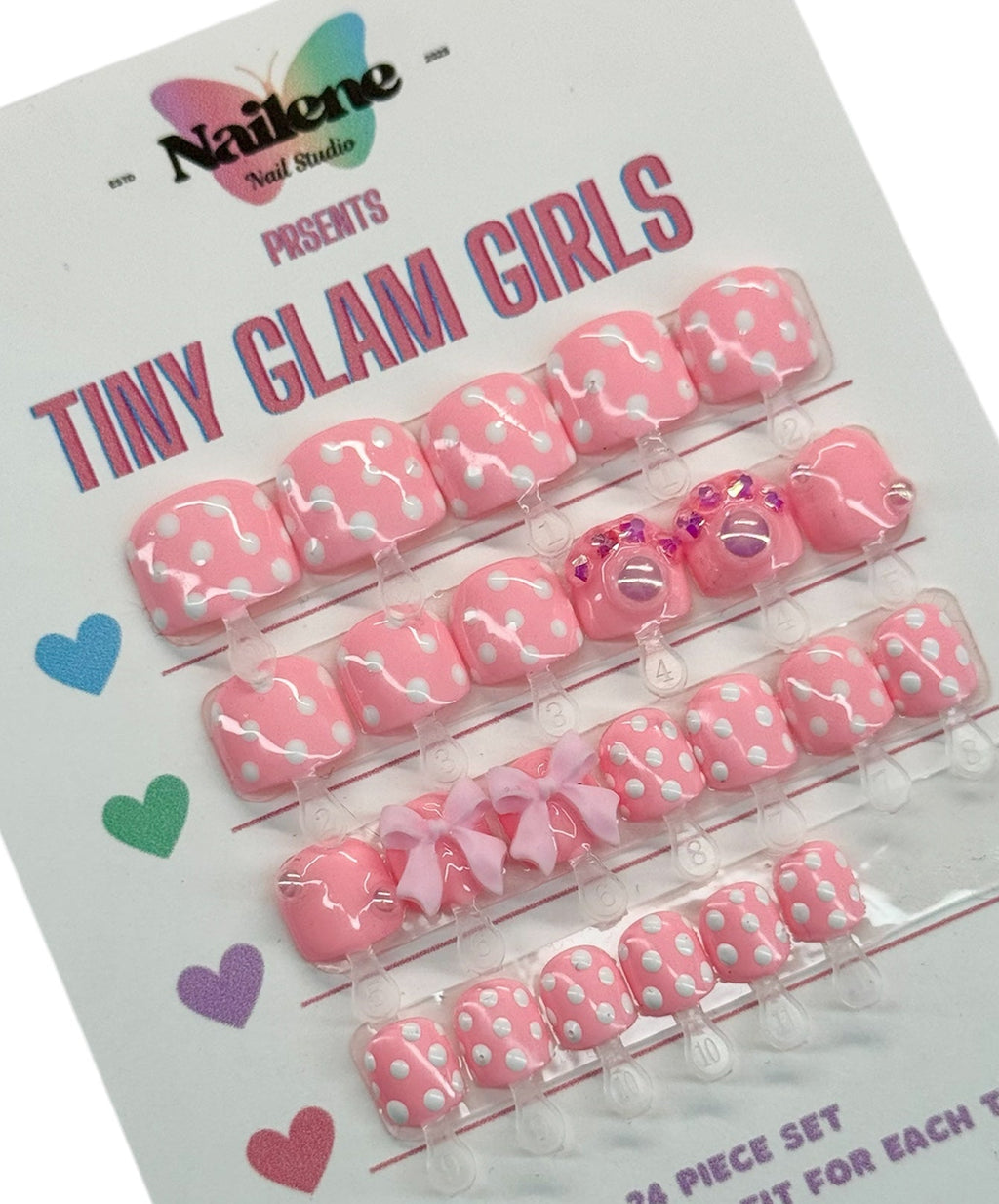 Packaging of 'Tiny Glam Girls' nail art decorations with pink and white designs on a white background.