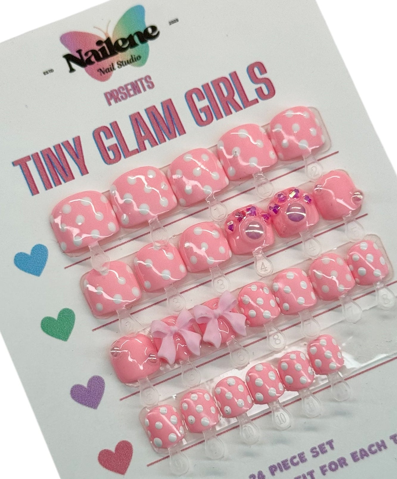 Packaging of 'Tiny Glam Girls' nail art decorations with pink and white designs on a white background.