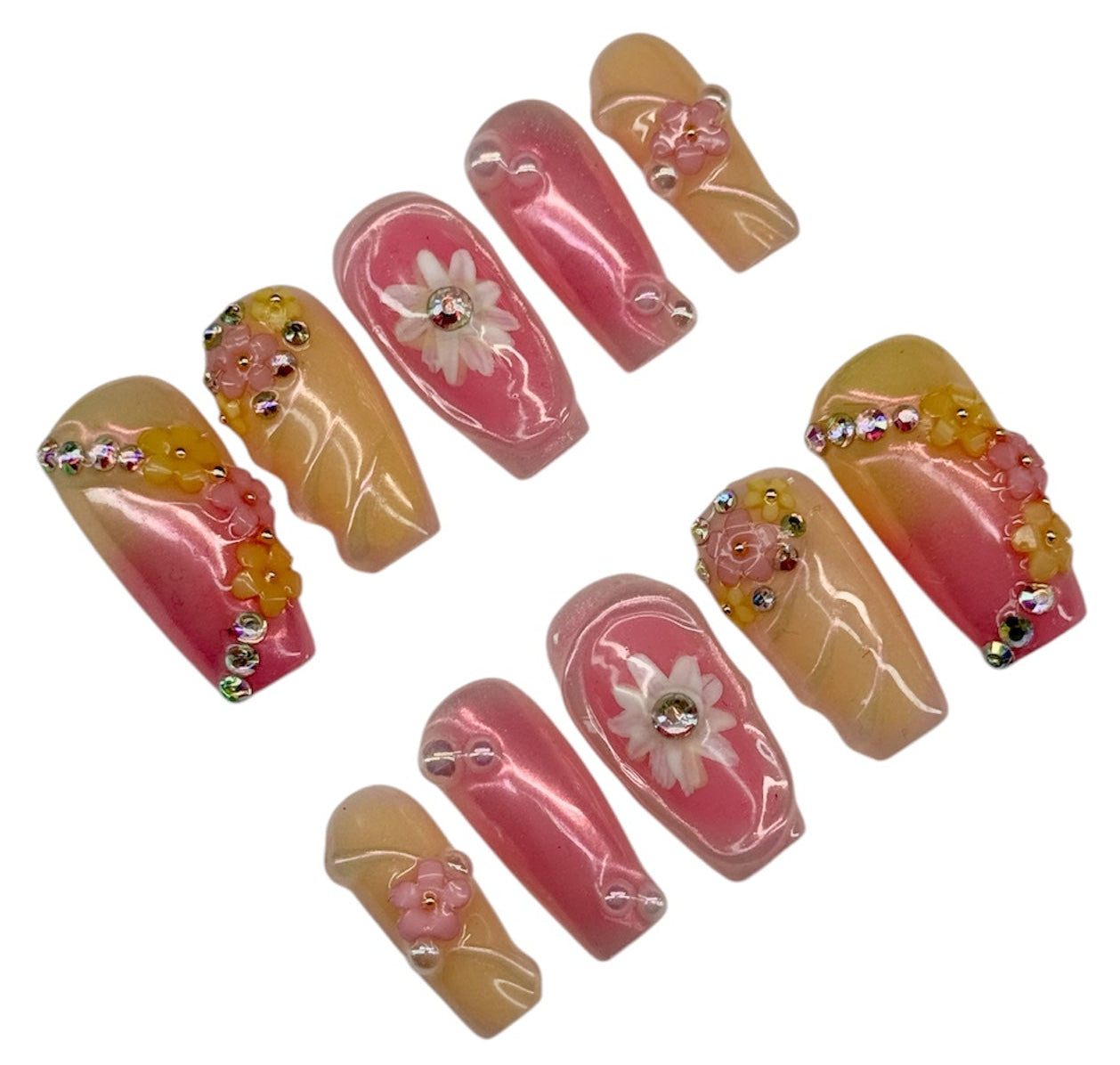 Set of decorative false nails with floral designs on a white background