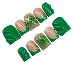 Set of green and beige false nails on a white background
