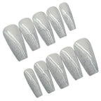 Set of white with glitter polish nail extensions on a white background