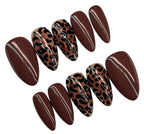 Set of brown press-on nails with leopard print design on a white background