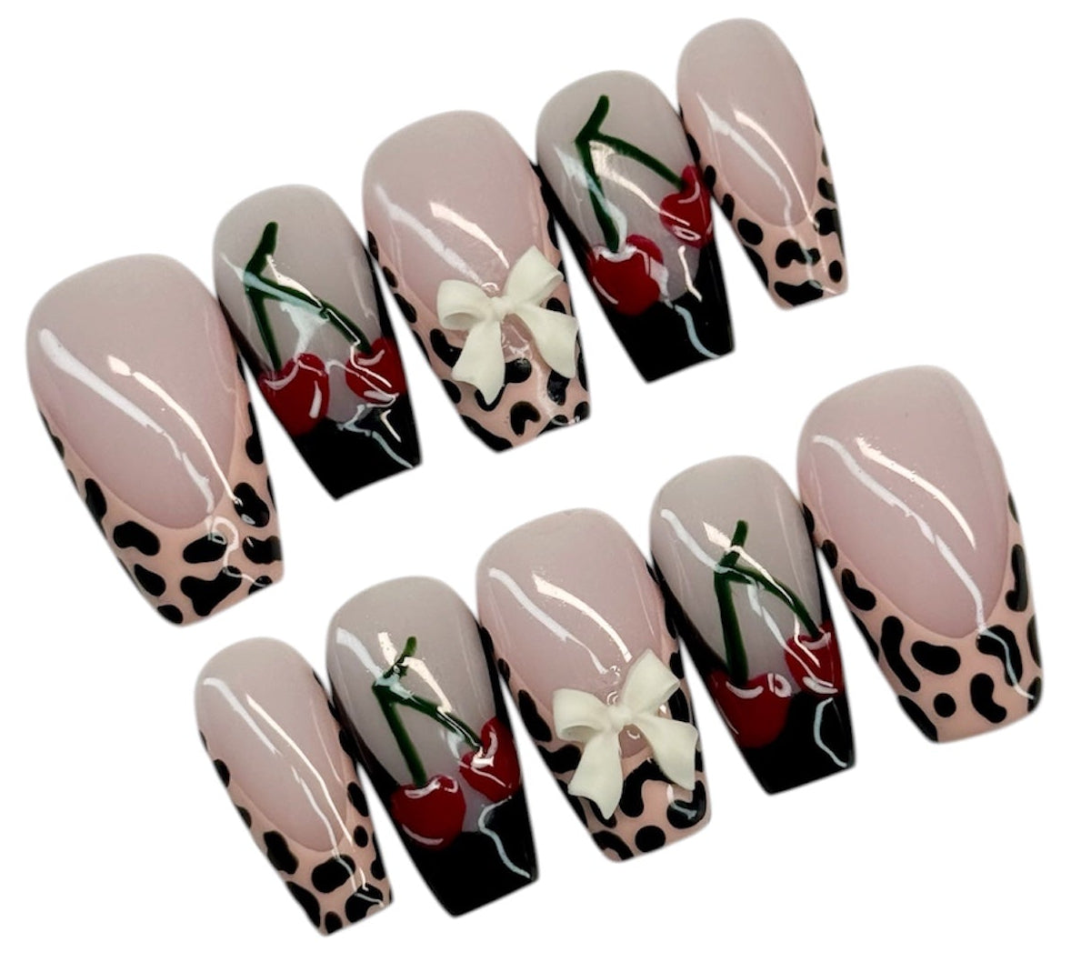 Set of press-on nails with various designs on a white background