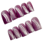 Set of purple cat eye glittery nail art on a white background