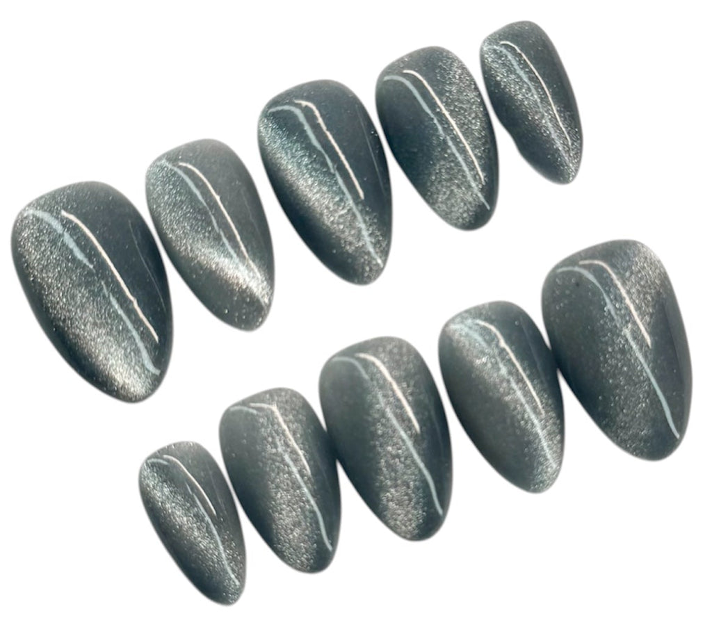 Set of metallic gray nail extensions on a white background