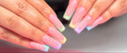 Close-up of hands with pastel nail polish on a blurred background