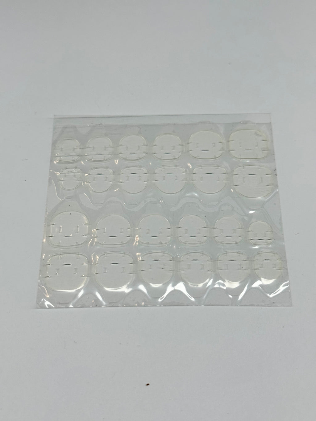 Sheet of adhesive tabs on a white background