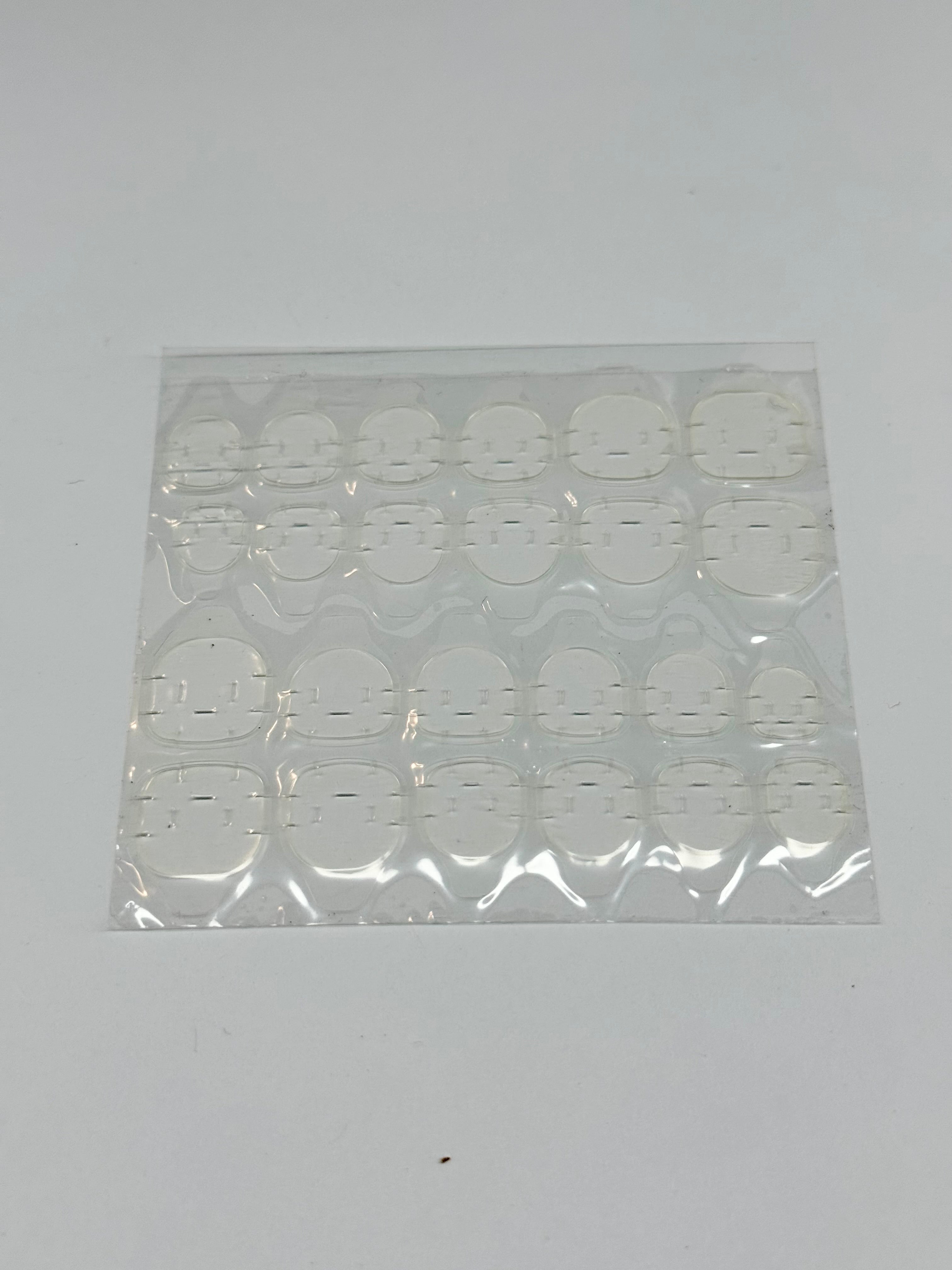 Sheet of adhesive tabs on a white background